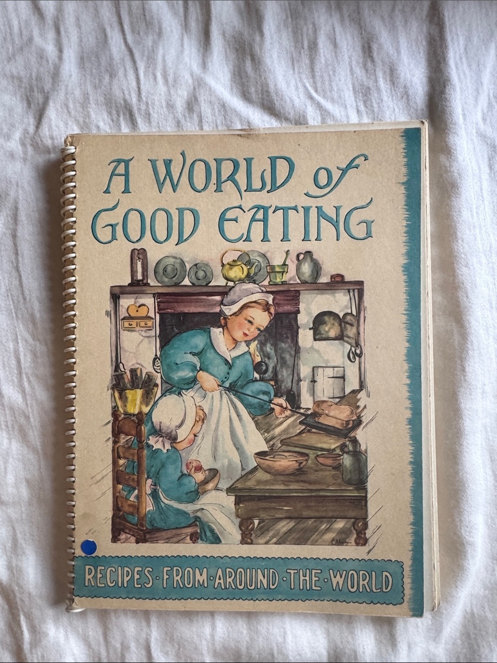 A World of Good Eating Cookbook - Cream & Teal Cover